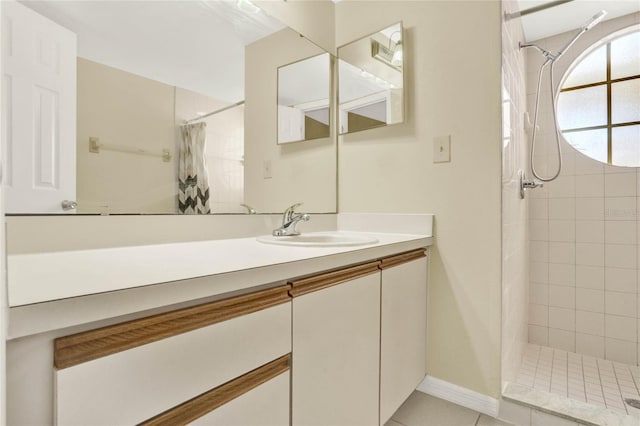 bathroom featuring walk in shower, vanity, and tile patterned floors