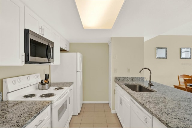 kitchen with sink, white cabinets, white appliances, light tile patterned floors, and light stone countertops