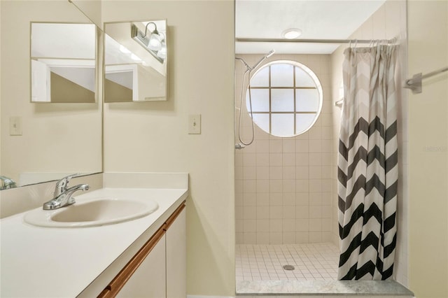 bathroom featuring walk in shower and vanity