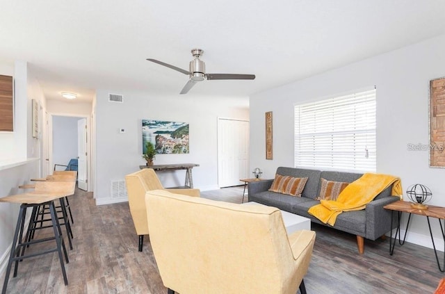 living room featuring dark hardwood / wood-style floors and ceiling fan