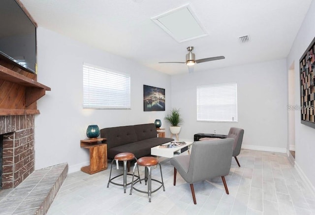 living room with a fireplace and ceiling fan