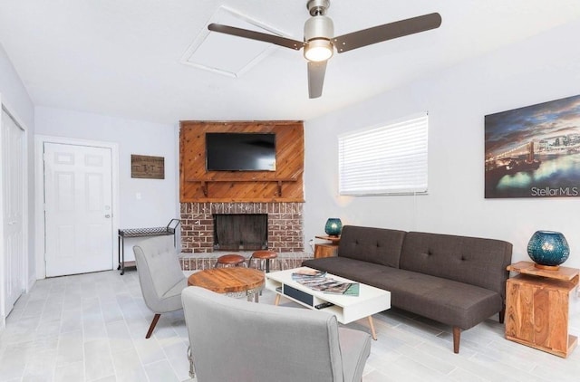 living room with ceiling fan and a fireplace