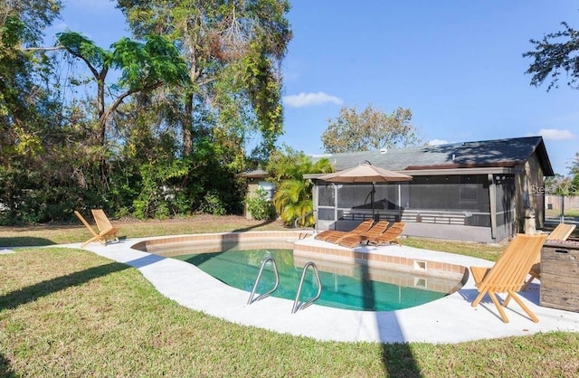 view of swimming pool with a sunroom, a patio area, and a yard