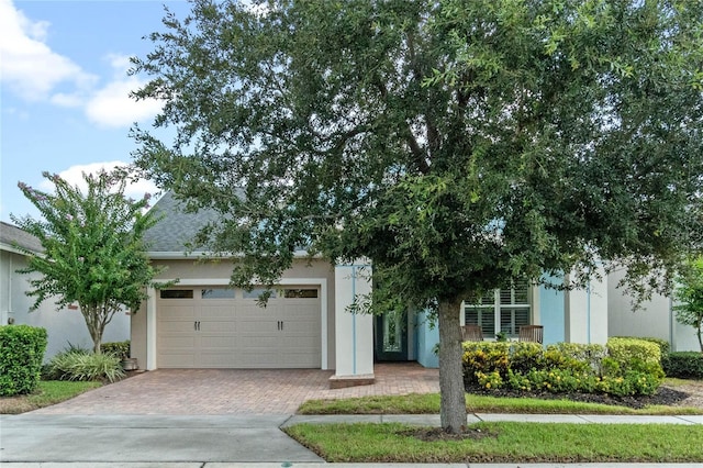 obstructed view of property featuring a garage