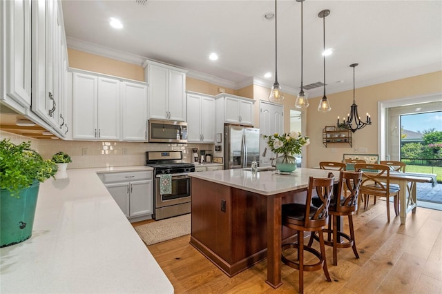 kitchen featuring light hardwood / wood-style floors, a kitchen island with sink, stainless steel appliances, and white cabinets