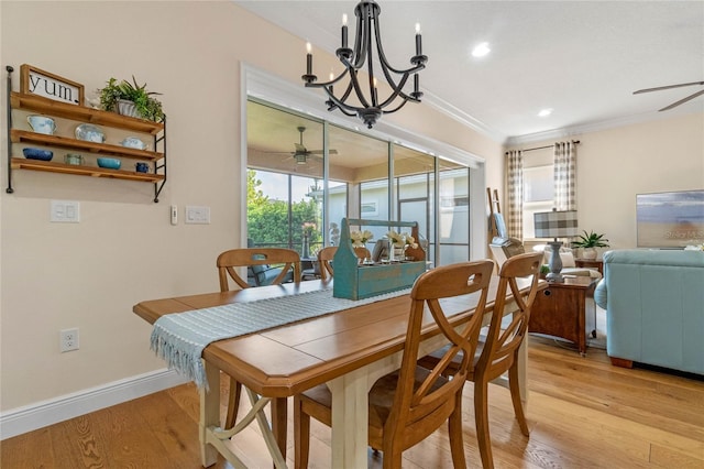 dining room with ceiling fan with notable chandelier, light hardwood / wood-style floors, and crown molding