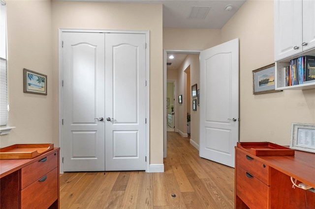 hallway with light wood-type flooring