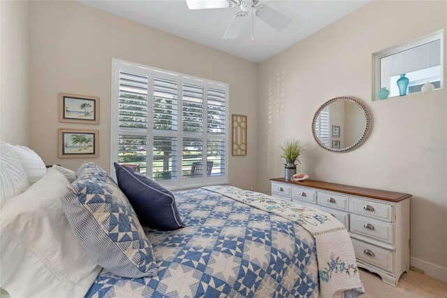 bedroom featuring light carpet, multiple windows, and ceiling fan