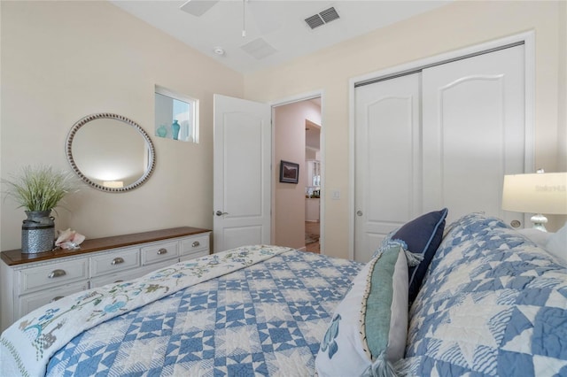 bedroom with ceiling fan and a closet