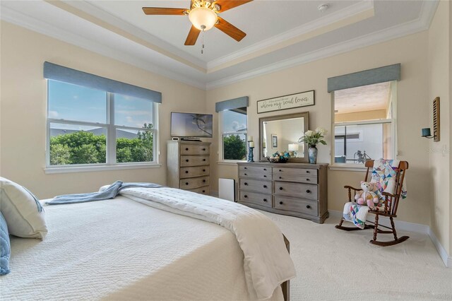 bedroom with carpet, ceiling fan, a raised ceiling, and crown molding