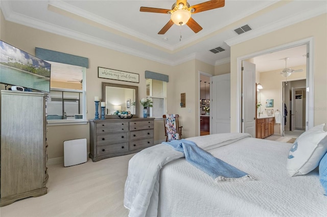 bedroom featuring ceiling fan, ensuite bath, light carpet, and ornamental molding