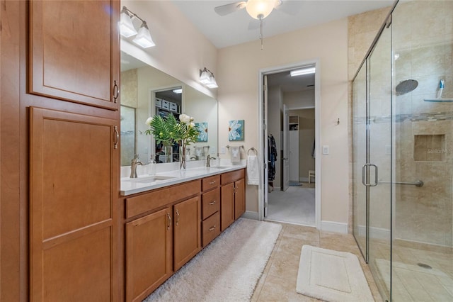 bathroom featuring tile patterned flooring, vanity, ceiling fan, and an enclosed shower