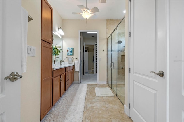 bathroom featuring ceiling fan, vanity, tile patterned flooring, and a shower with door