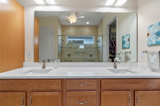 bathroom featuring ceiling fan, walk in shower, and vanity