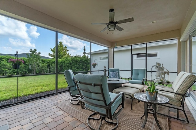 sunroom featuring ceiling fan