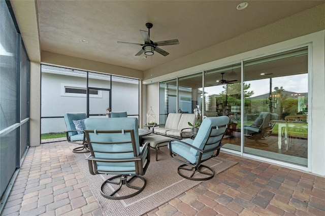 sunroom featuring ceiling fan