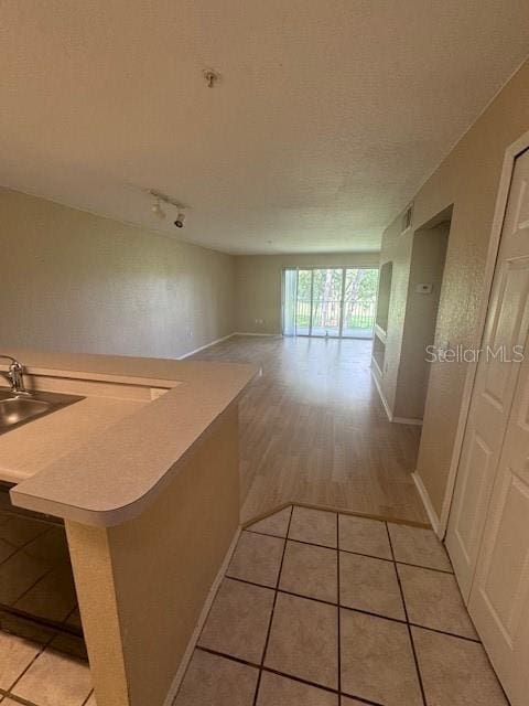 corridor featuring sink and light hardwood / wood-style floors