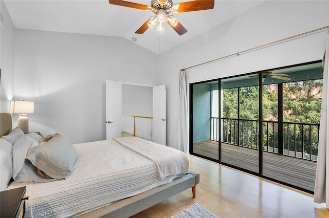 bedroom with a ceiling fan, access to exterior, lofted ceiling, and wood finished floors