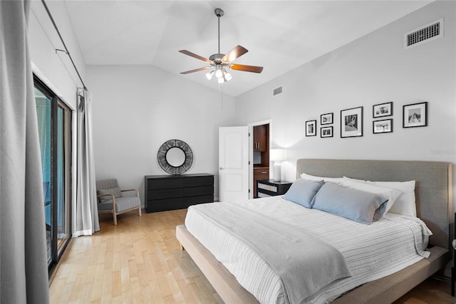 bedroom with light wood-style flooring, visible vents, vaulted ceiling, and ceiling fan
