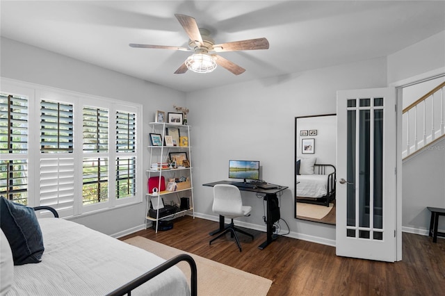 bedroom featuring a ceiling fan, baseboards, and wood finished floors