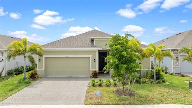 view of front of home featuring a garage and a front lawn