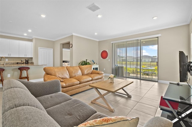 living room featuring light tile patterned floors and crown molding