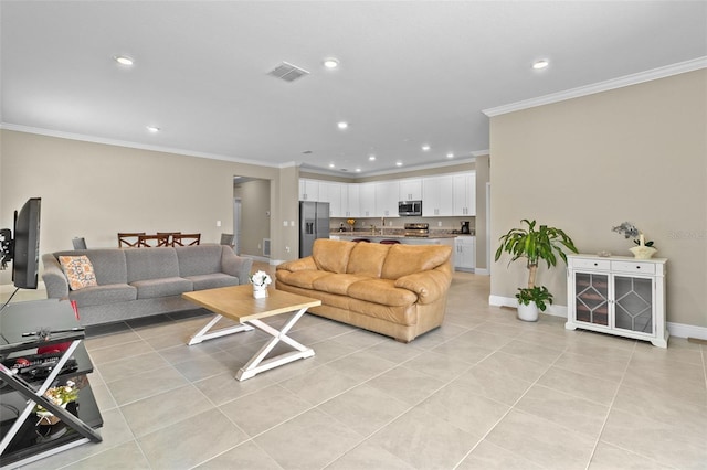 living room featuring ornamental molding and light tile patterned floors