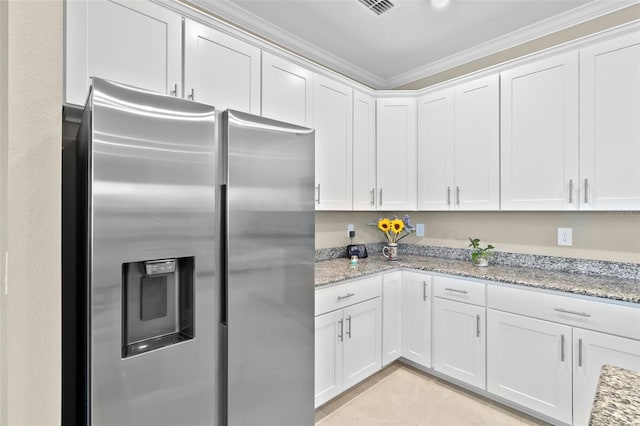 kitchen with white cabinets, light stone countertops, crown molding, and stainless steel fridge with ice dispenser