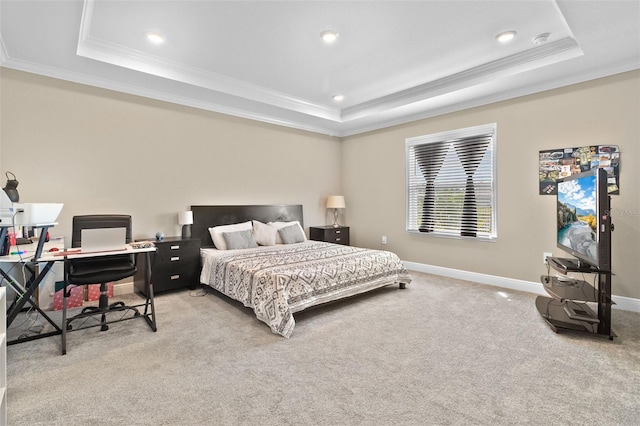 carpeted bedroom featuring a raised ceiling and ornamental molding