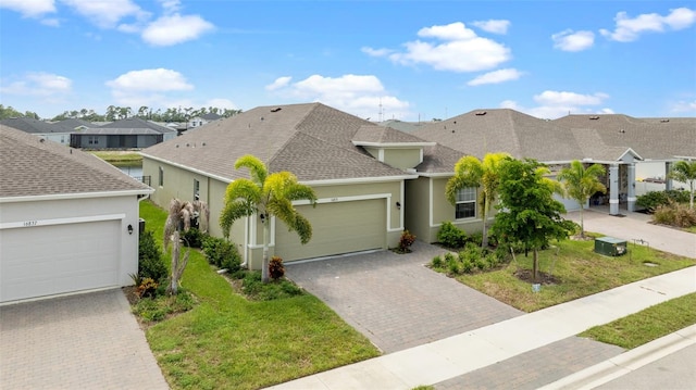 view of front of property with a front yard and a garage