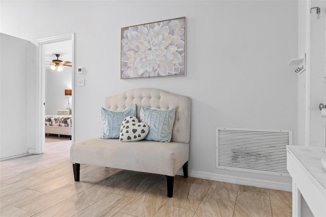 sitting room featuring ceiling fan and light hardwood / wood-style flooring