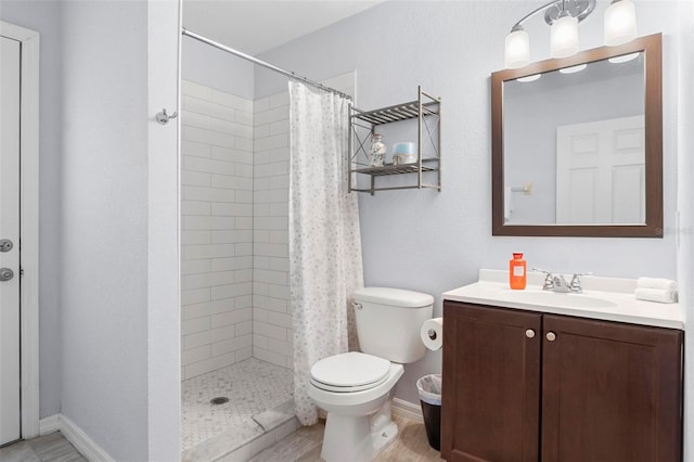 bathroom featuring a shower with curtain, vanity, and toilet