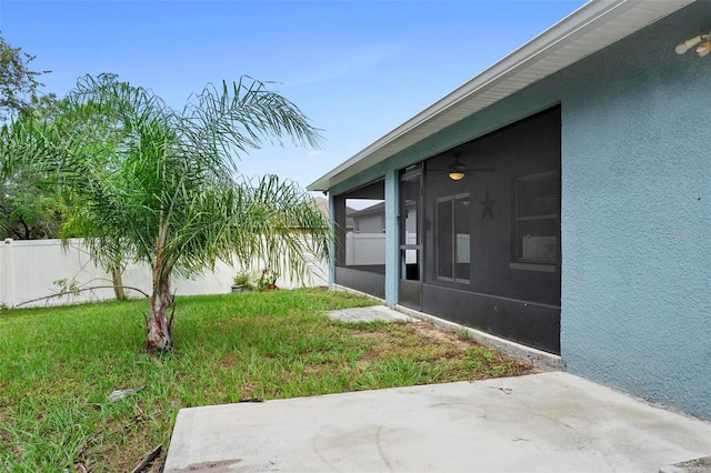 view of yard featuring a sunroom and a patio area