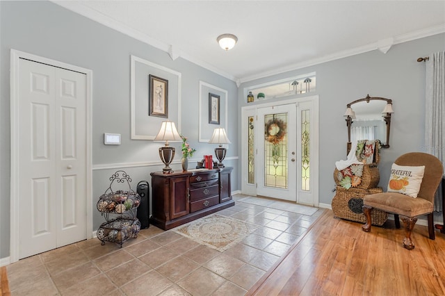 entrance foyer featuring crown molding and light hardwood / wood-style floors