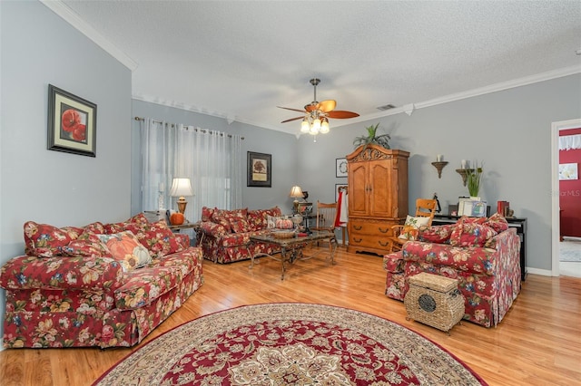 living room featuring a textured ceiling, ceiling fan, and light hardwood / wood-style flooring