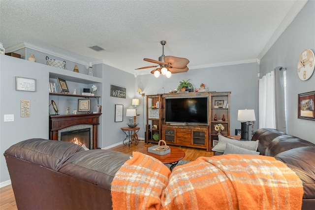 4609 Indian River Dr, Cocoa, FL 32927 - living room featuring a ceiling fan, crown molding, visible vents, and light wood-style flooring