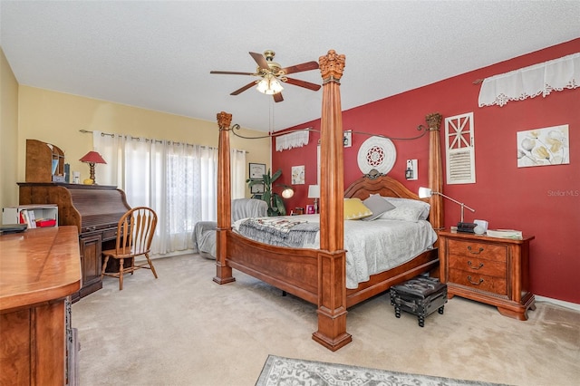 carpeted bedroom featuring a textured ceiling and ceiling fan