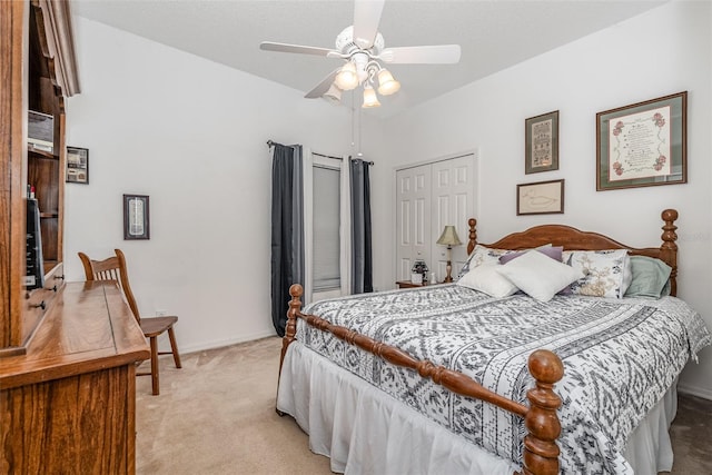 bedroom featuring ceiling fan, light colored carpet, and a closet