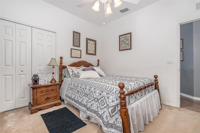 carpeted bedroom featuring ceiling fan and a closet