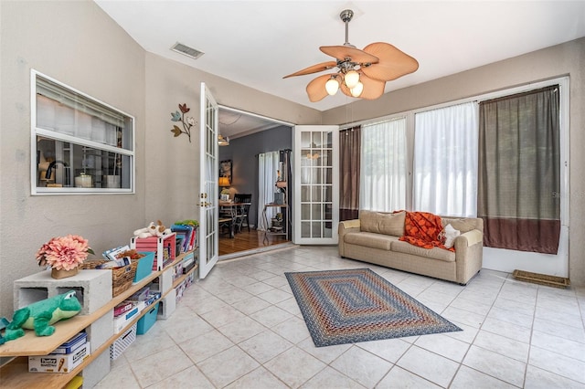 unfurnished living room featuring light tile patterned flooring and ceiling fan