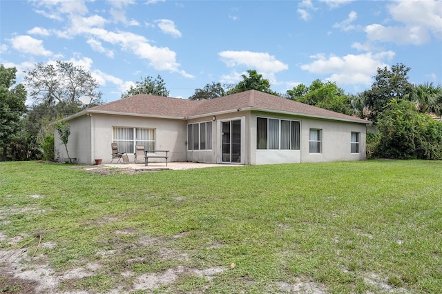 4609 Indian River Dr, Cocoa, FL 32927 - rear view of house with a shingled roof, a patio area, a lawn, and stucco siding