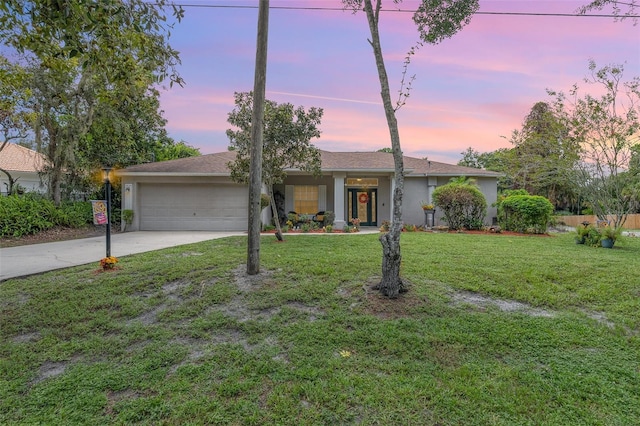 4609 Indian River Dr, Cocoa, FL 32927 - ranch-style house with stucco siding, an attached garage, a front yard, and concrete driveway
