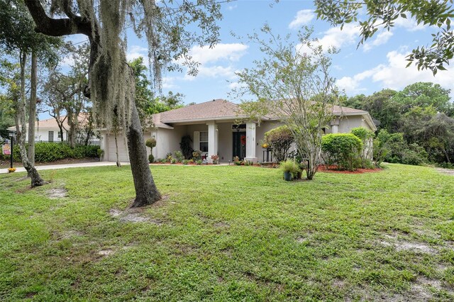 single story home with a garage and a front lawn