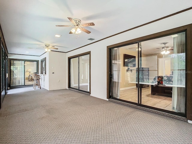 carpeted spare room featuring crown molding