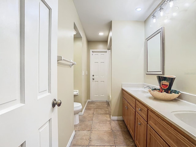 bathroom featuring vanity, toilet, and tile patterned flooring