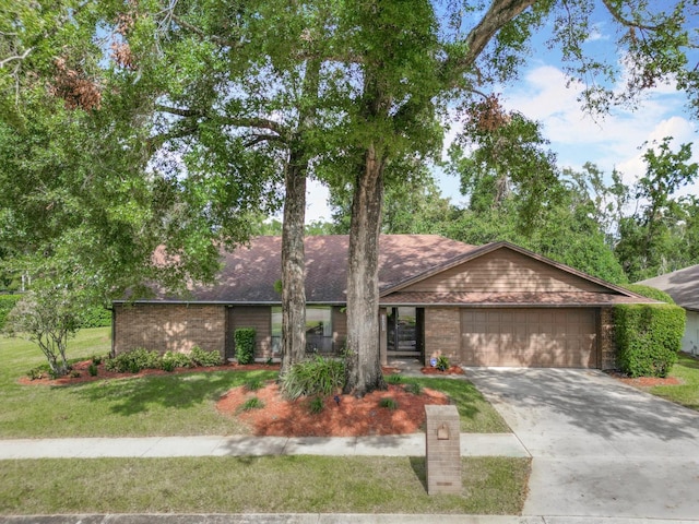 ranch-style house featuring a front lawn and a garage