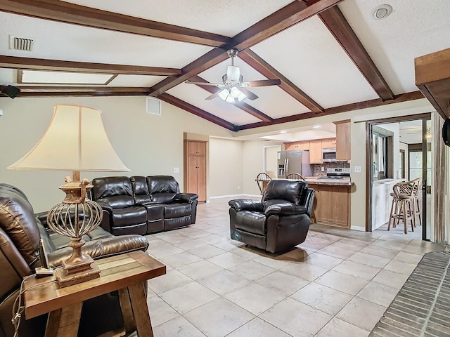 tiled living room with lofted ceiling with beams, a textured ceiling, and ceiling fan