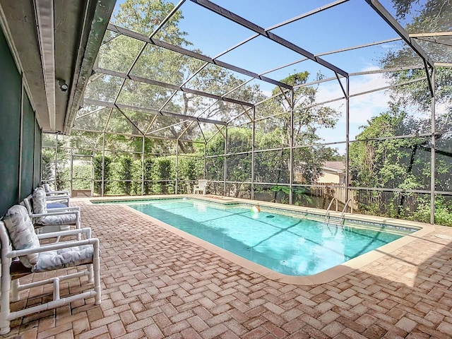 view of swimming pool with a patio and glass enclosure