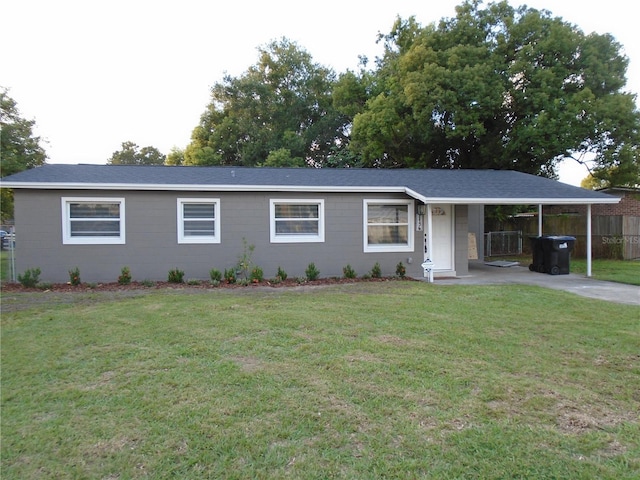 ranch-style house featuring a front lawn and a carport