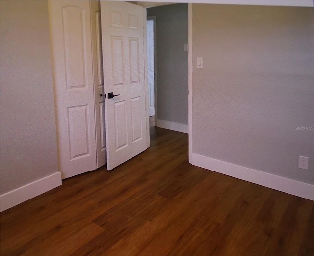 unfurnished bedroom with dark hardwood / wood-style floors